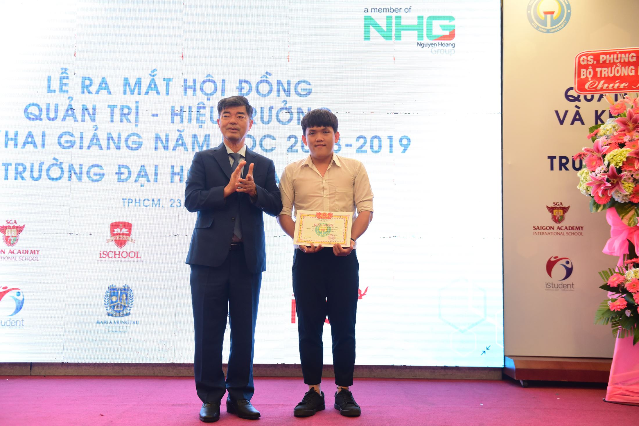 The student who got the highest score on the University entrance examination was awarded a certificate of merit.