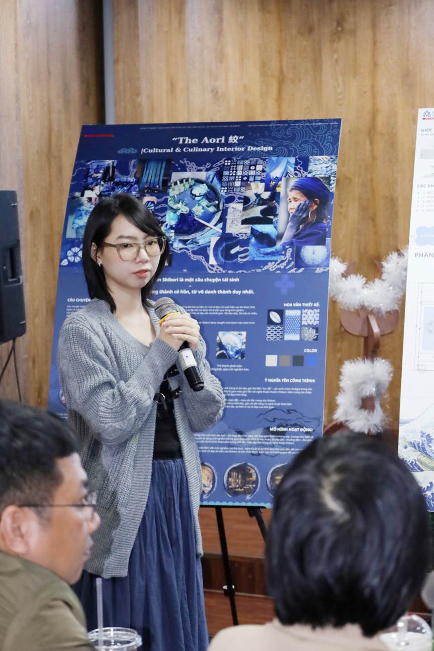A person holding a microphone in front of a poster
AI-generated content may be incorrect.