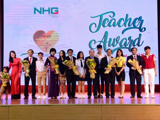 The touching moment when students are giving flowers to their teachers.