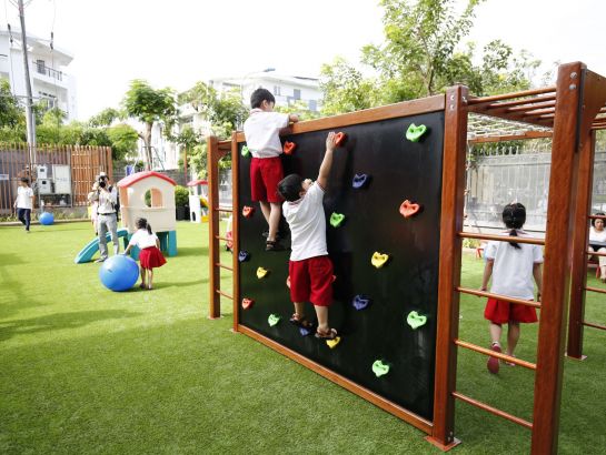SNA elementary students play at outdoor playgrounds with colorful games