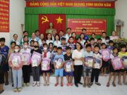 The joyful smiles of children receiving gifts to support their education. 